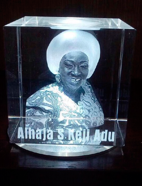 Custom cube-shaped glass trophy with engraved details and spinning display stand